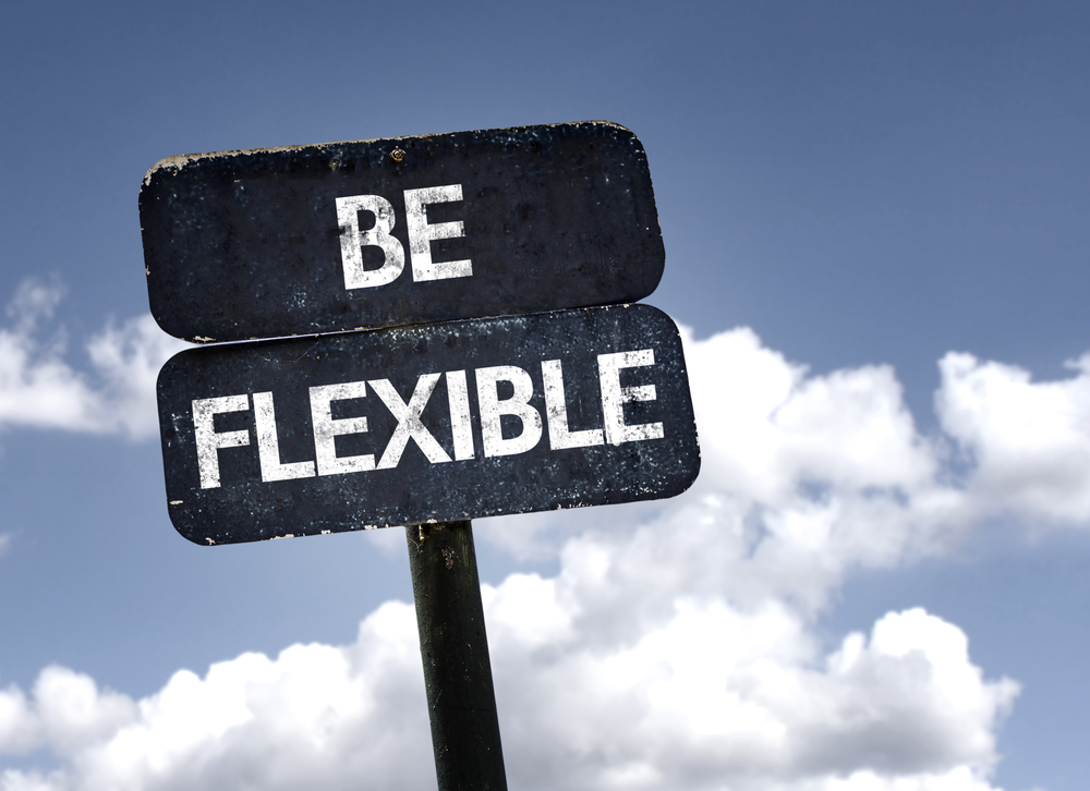 Be Flexible sign with clouds and sky background