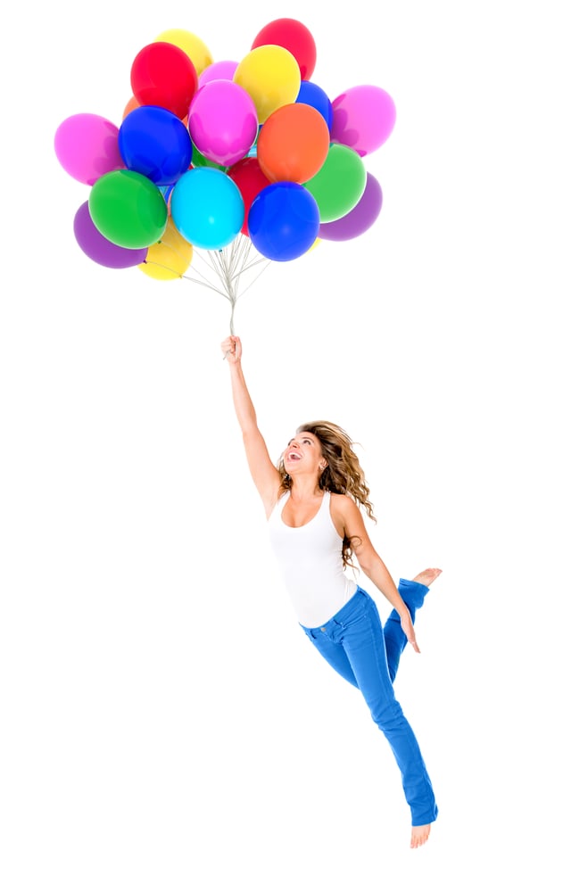 Happy woman holding balloons - isolated over a white background