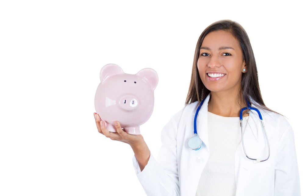Healthcare reform concept- doctor holding piggy bank. Medical insurance, reimbursement Happy smiling female doctor, nurse holding piggy bank isolated on a white background..jpeg