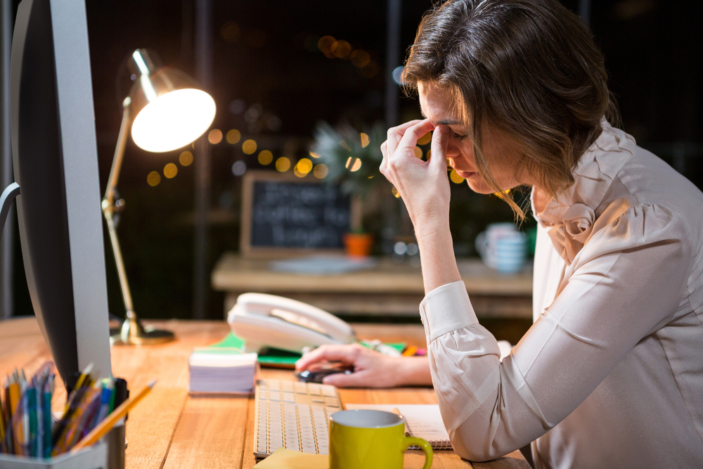 Stressed businesswoman sitting at her desk in the office