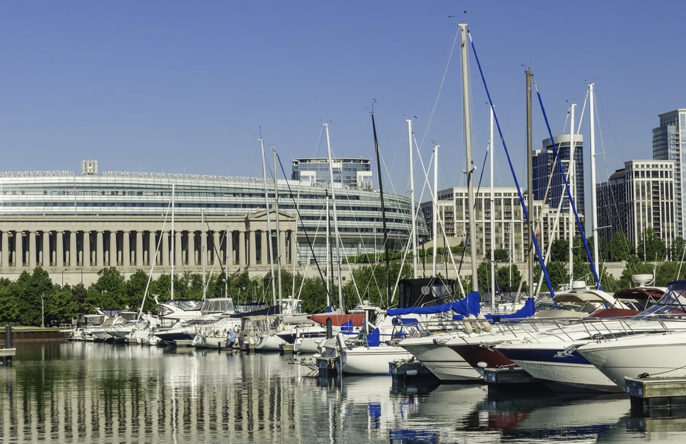 Urban magnetism Row of yachts docked in Burnham Harbor by Soldier Field, home of the Chicago Bears professional football team, along the lakefront on a sunny spring morning in Chicago